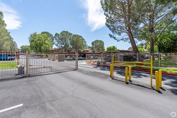the entrance to West Pak Villas Apartment community  with a gate and yellow posts out front